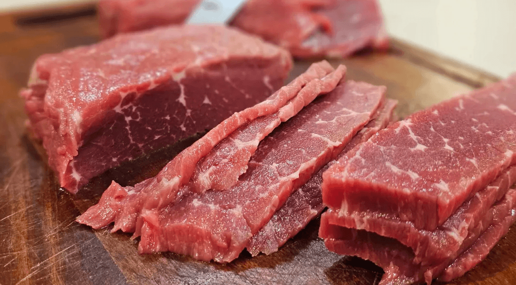 Fresh beef being sliced for jerky